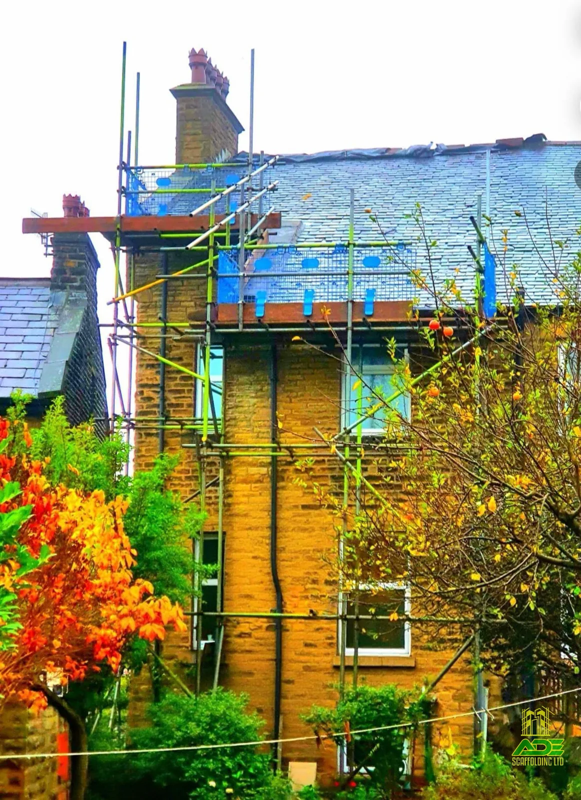 Scaffold with temporary roof cover on a stone terrace during re-roofing